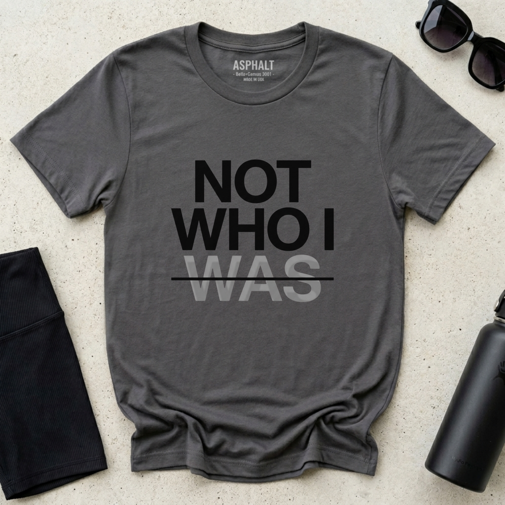 Minimalist Christian t-shirt with “Not Who I Was” redemption message in Asphalt Gray. Modern Christian streetwear t-shirt with testimony inspired message, made by Eternal Thread Apparel, a Christian apparel store.