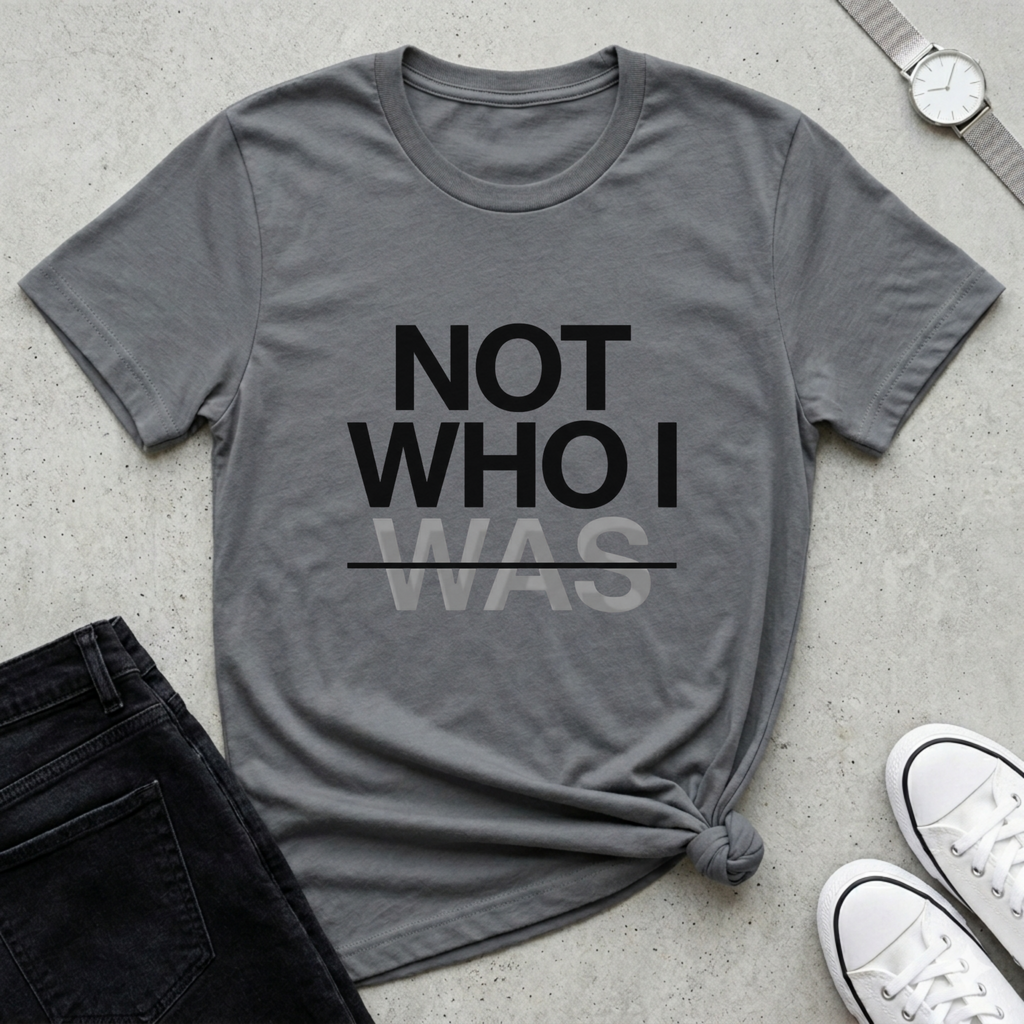Minimalist Christian Streetwear t-shirt with “Not Who I Was” redemption message in Storm Gray. Modern Christian streetwear t-shirt with testimony inspired message, made by Eternal Thread Apparel, a Christian apparel store.