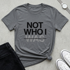 Minimalist Christian Streetwear t-shirt with “Not Who I Was” redemption message in Storm Gray. Modern Christian streetwear t-shirt with testimony inspired message, made by Eternal Thread Apparel, a Christian apparel store.