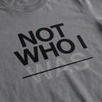 Zoomed in detail shot of the "Not Who I Was" Modern Christian Streetwear t-shirt sold by Eternal Thread Apparel, in Storm Gray and two other colors.